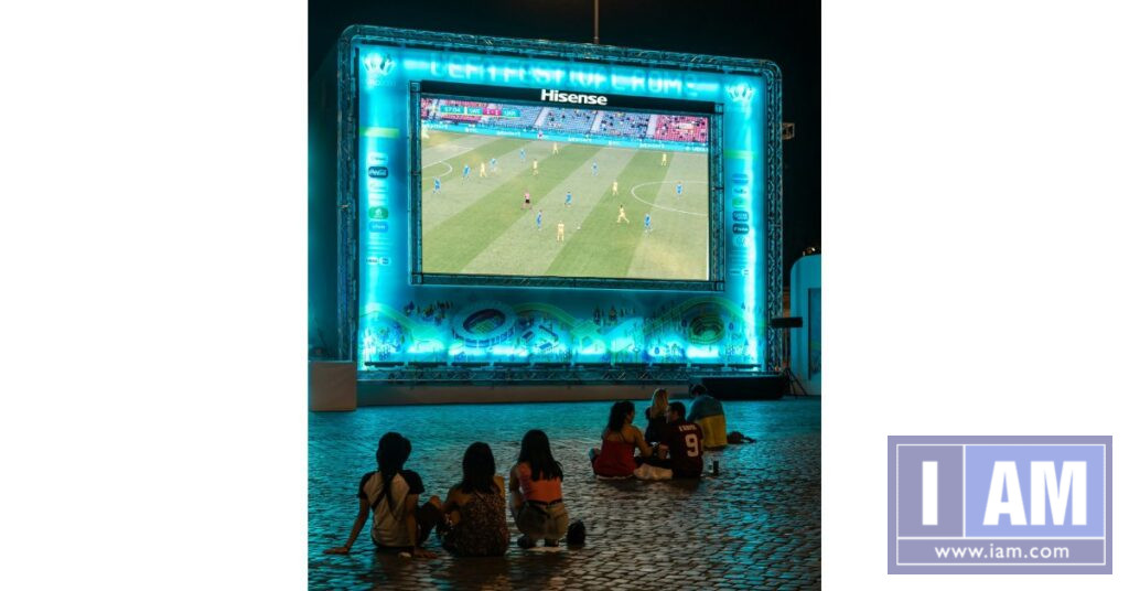 Kids watching soccer on bigscreen