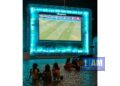 Kids watching soccer on bigscreen