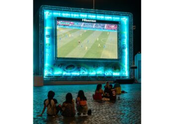 Kids watching soccer on bigscreen