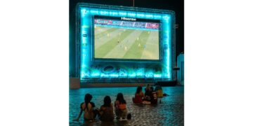 Kids watching soccer on bigscreen