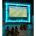 Kids watching soccer on bigscreen
