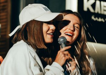 Two women singing karaoke