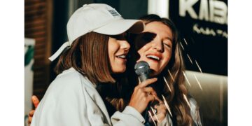 Two women singing karaoke