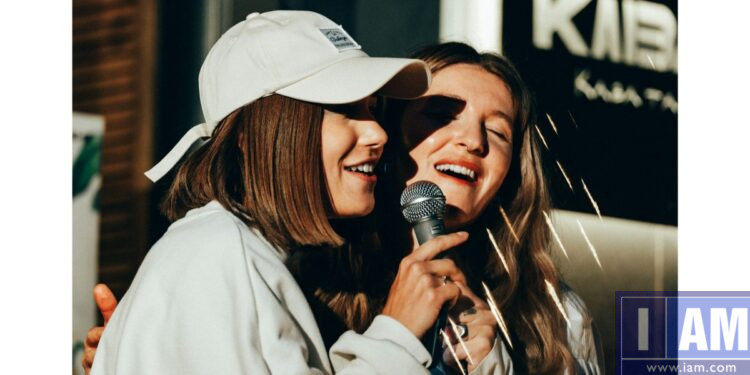 Two women singing karaoke