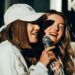 Two women singing karaoke